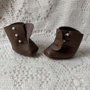 Vintage brown doll shoes with three tiny buttons